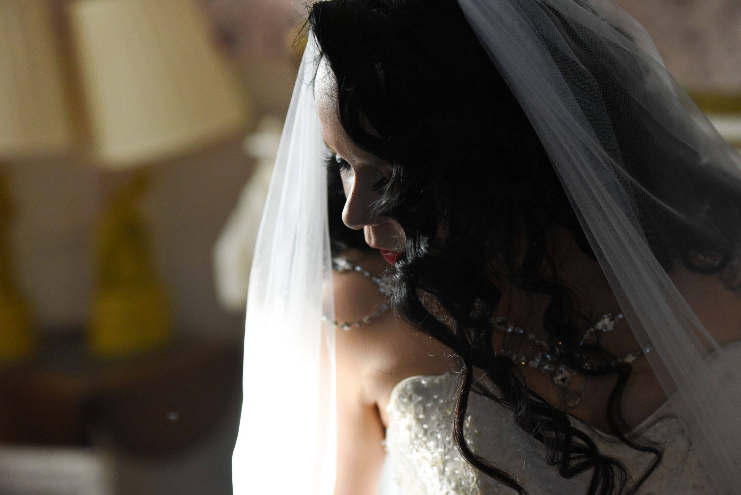 Bride poses in a mirror.
